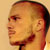 Static 50x50 pixel buddy icon showing a close-up profile of a person with short dark hair and light skin against a beige background.