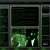 Pixelated green and black image showing a figure with glowing eyes holding an object near a large green shape inside a dark rectangular frame.