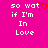 A bright pink background displays white pixelated text reading "so wat if I'm In Love" with a red heart symbol replacing the 'o' in 'what', shown twice side-by-side.