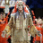 Pixelated image of a bearded figure in light clothing with orange accents, next to blue background text reading 'Chief illini-wek will live on'