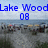 Pixelated image showing blue text 'Lake Wood' above '08' over a blurred landscape background with water and trees.