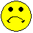 Two identical yellow circular faces with black eyes and downturned mouths on a gray background.