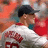Pixelated image of a baseball player in white uniform with red accents, standing against solid red background with text overlays.