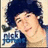 Pixelated image of a person with dark hair wearing a blue top, holding an object with partially visible text.