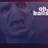Pixelated image of a dark blue-toned face with visible eyes and mouth, set against a gradient background featuring white cloud-like shapes on the right.