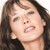 Static 50x50 pixel icon showing a close-up of a woman's face with dark hair, visible teeth, and pink lips against a white background.