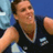 Pixelated static image of a person in athletic attire with mouth open, likely mid-action or expression, against a blue background.