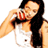 Pixelated static image of a person with long dark hair wearing a white tank top and black straps, holding a red object near their face against a plain background.