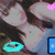 A pixelated image of a person with long dark hair, light skin, and a blue top, featuring a cyan circular symbol and a blue rectangular symbol with a white icon.