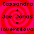 A static image with a red and pink spiral background displaying text in black pixelated font.