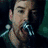A person singing into a microphone with changing facial expressions , set against a dark green background with red and white circular elements
