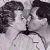 A 50x50 pixel animated contact sheet showing two grayscale frames of a couple kissing on the left and green text "Original Icons .com" on the right against a dark background.