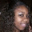 A person with curly hair and makeup appears in three showing slight head movement against a dark background