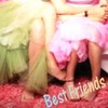 Two figures in a close embrace, one in green and one in pink, with 'Best Friends' text at the bottom.