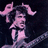 Pixelated pink and purple character with flowing hair holding a guitar, next to bold white text reading "AC/DC CONCERT TONITE" on dark background.