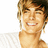 Pixelated close-up of a person with light brown hair and a white shirt, smiling with visible teeth against a plain white background.