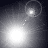 A grayscale animation of a bright circular light source moving across four , with faint dotted trails and occasional concentric rings