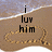Beach scene with 'i luv him' text in black pixelated font over sand, wave at top, and a heart drawn in the sand.