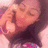 Pixelated close-up of a person with closed eyes, light skin tone, and dark hair wearing a dark top against a pinkish background.