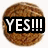 Two circular brown cookies with textured surfaces, each featuring black rectangular text boxes containing white uppercase letters.
