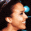 Pixelated profile image of a person with dark hair and light skin, showing three side-profile views with subtle facial expression changes against a black background with blue circular elements.