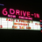 Pixelated graphic with pink '6 Drive-In' text above a white and orange striped banner on black background.