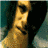 Four pixelated show a person with dark hair in different poses: hand near face, covering mouth, smiling, and neutral expression