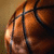 A basketball with visible seams and texture appears on the left side of a split-screen, while the right side displays the text "Baller 4 Life" in light blue pixelated letters on a black background.