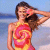Pixelated static image of a person in a colorful swimsuit on a beach, with one arm raised near the head.