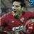 Pixelated static image of a person in red sports attire with visible facial features and partial background elements.
