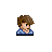 Pixelated avatar of a person with brown hair, light skin, and a blue checkered shirt against a gray background.
