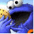 A 2x2 contact sheet of four animated frames showing a blue Sesame Street character eating a cookie with text elements on light blue backgrounds.