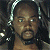 A 50x50 pixel animated buddy icon featuring a split composition with a person on the left and green text on the right, displayed as part of an animated contact sheet.