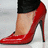 A red high-heeled shoe on a foot with black pants, accompanied by text fragments and a numeric sequence.