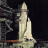 Pixelated static image of a white rocket on a dark background with faint structural elements on the left.