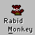Pixelated red monkey with white teeth and green pants, waving one arm against gray background.