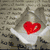 Four distinct buddy icons arranged in a : a heart on a stone background, a heart-shaped apple, a cartoon couple, and a black-and-white couple with text