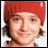 Animated contact sheet of a person wearing a red knit beanie with subtle facial expression changes across 17 frames, some frames containing text overlays and small heart symbols.