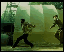 Animated sequence of two figures in dark clothing performing martial arts moves against a greenish background with arched structures.