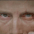 A pixelated close-up of a human face showing eyes, eyebrows, and part of the nose with neutral expression.