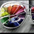 A circular icon with a rainbow gradient background showing subtle motion blur across its segments.