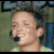 A pixelated image split into two sections: a person with short dark hair wearing a headset on the left, and blue text reading "I'm Moving On's Baby" on a light blue background on the right.