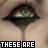 12 showing a close-up of a person's eye with tears, accompanied by pixelated text forming a phrase