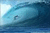 A pixelated blue-toned image depicting a large ocean wave curling over with sunlight reflecting off the water's surface.