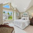 Pixelated static image of a room interior with multiple windows showing outdoor greenery and blue sky, furniture, and a light-colored wall background.
