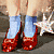 A contact sheet of two animated frames showing a character's lower legs and feet in red shoes with blue socks, next to green text reading "Original Icons .com" on a dark background.