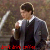 A person in a gray blazer and dark sweater holds a white cup, with red text reading 'don't drink coffee' on the left side.