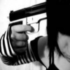 Black-and-white image of a hand gripping a handgun pointed toward the viewer, with a striped sleeve visible on the arm.