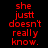 Red pixelated text "she just doesn't really know." on black background with white rectangular overlays shifting across the text.