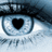 Pixelated close-up of a stylized eye with a black heart-shaped pupil, dark eyeliner, and light blue-gray tones, set against a blurred background.